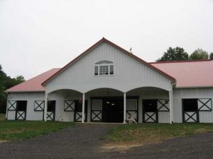 72'x200' Arena with 68'x84' Stall Barn and 36'x12' Portico Front View